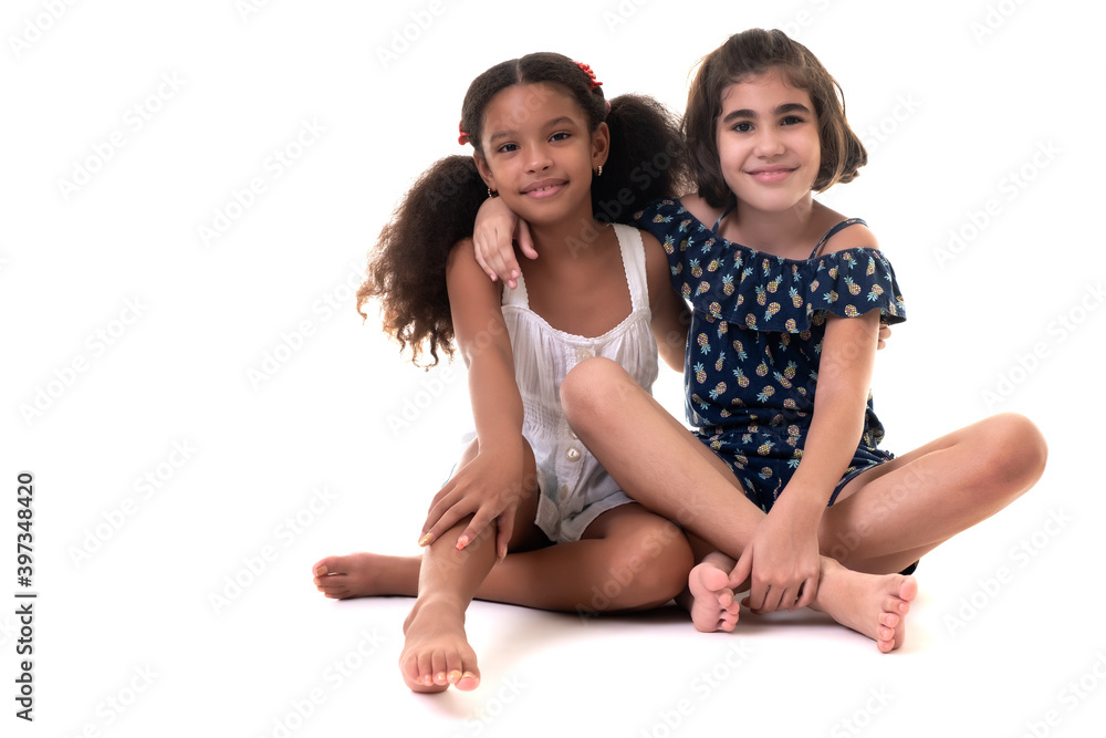 Two friendly small girls hugging isolated on white Two friendly small girls hugging isolated on white