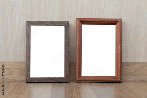 Wood frames on the beige wall backdrop. Office or home interior. Copy space, moc up