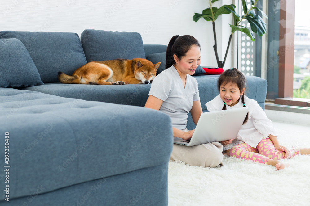Asian mother and daughter spend their vacations in the living room. Asian mother and daughter spend their vacations in the living room.