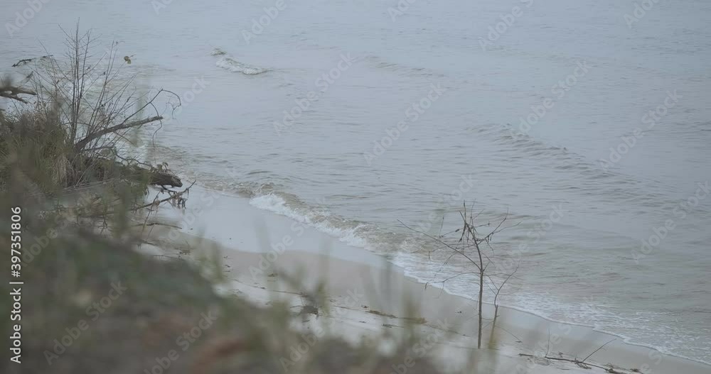 Calm waves of river splashing over sandy bank. Spring or autumn waters outdoors. Tranquility and nature concept. Beauty of nature. Cinema 4k ProRes HQ. Calm waves of river splashing over sandy bank. Spring or autumn waters outdoors. Tranquility and nature concept. Beauty of nature. Cinema 4k ProRes HQ.