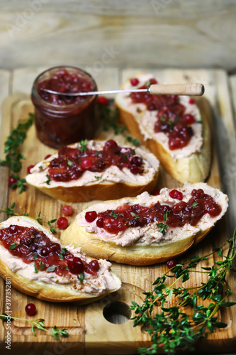 Sandwiches with turkey or duck pate and cranberry sauce. Festive snack.