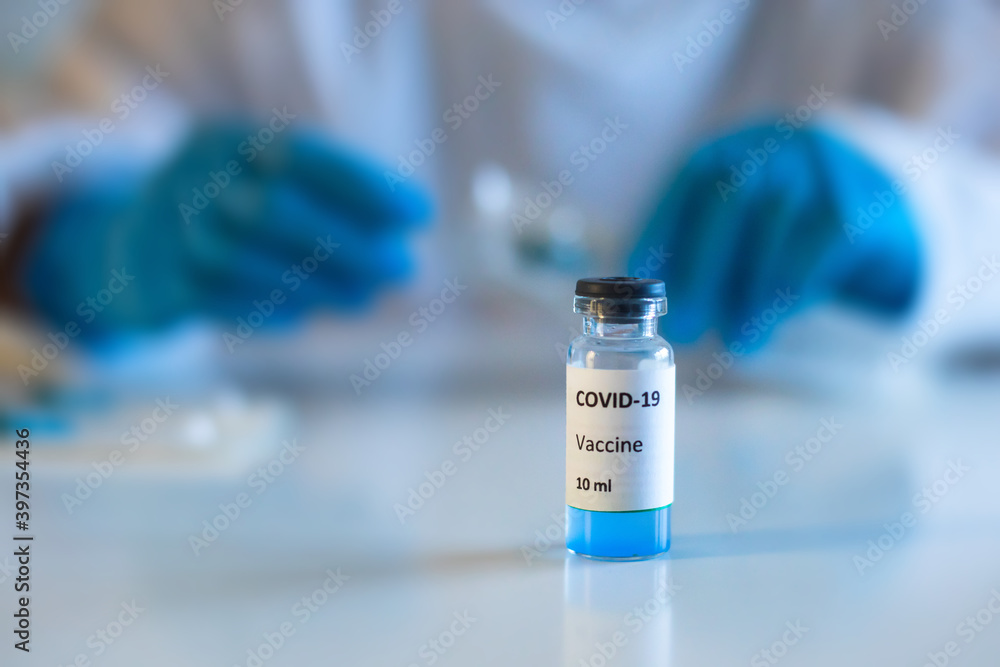 Concept of Covid 19 vaccine vaccinating, development and creation, doctor or scientist in laboratory holding a single dose of 2019-ncov vaccine, a syringe and ampule with SARS-CoV-2 vaccination Concept of Covid 19 vaccine vaccinating, development and creation, doctor or scientist in laboratory holding a single dose of 2019-ncov vaccine, a syringe and ampule with SARS-CoV-2 vaccination