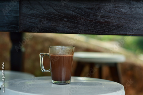 Fresh drink in the morning with a glass of hot chocolate on the table. a cup of hot chocolate to relax in the morning