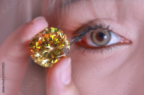 .Pick up the Yellow sapphire diamond to look at. photo