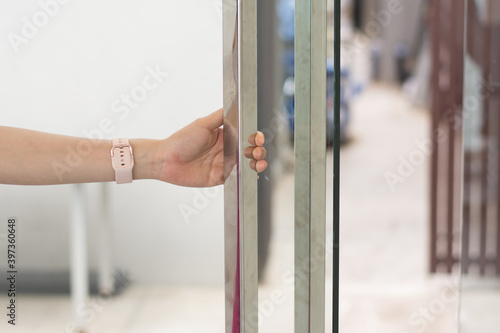 Women hand opens door Close up hand open door. © sek_gt