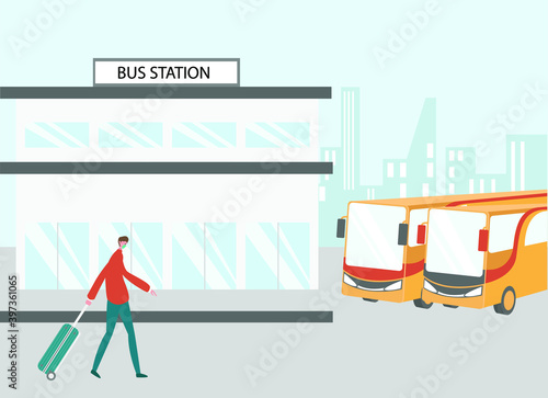 Male passenger wearing face mask and walking in bus station while carrying suitcase