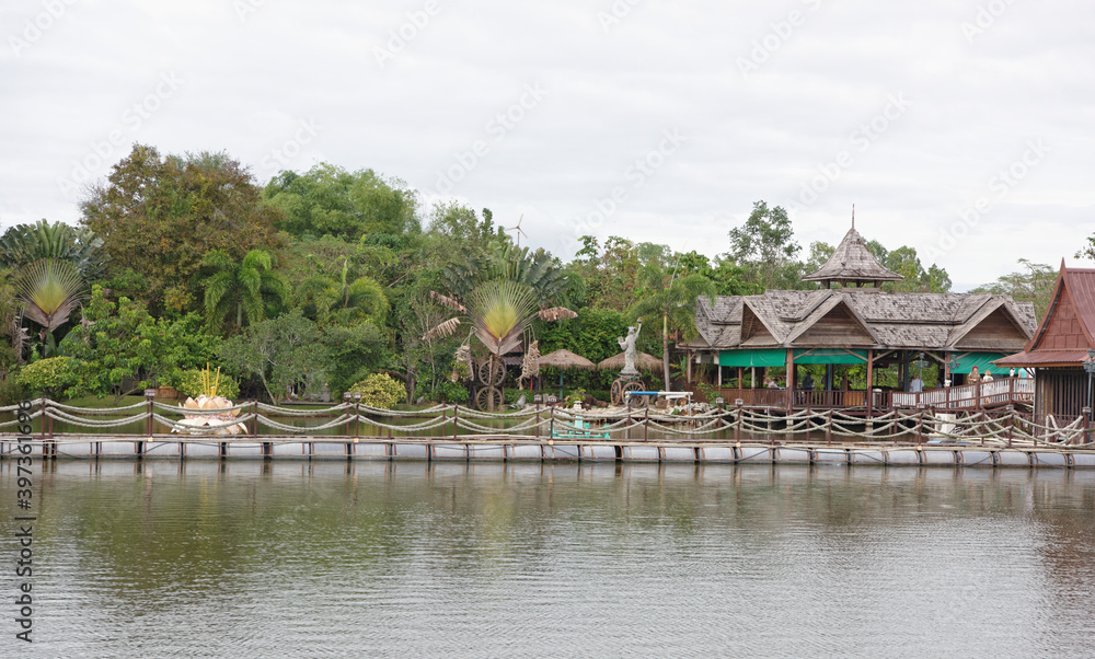 Lake in the park. Tourists drink tea and look at fish in the water Lake in the park. Tourists drink tea and look at fish in the water