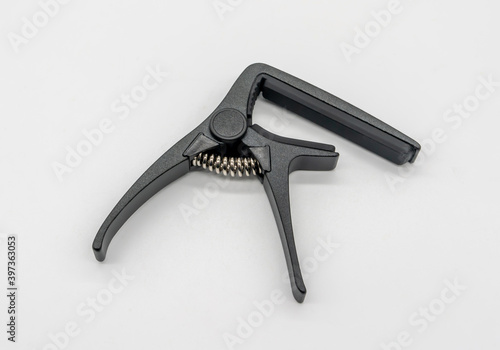 Matte black capo for acoustic and classical guitar isolated on white