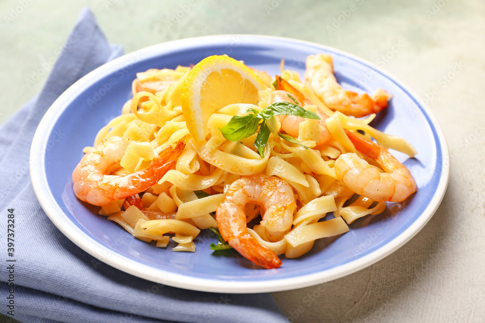 Plate of tasty pasta with shrimps on table Plate of tasty pasta with shrimps on table