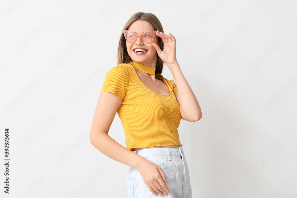 Happy woman with stylish sunglasses on light background Happy woman with stylish sunglasses on light background