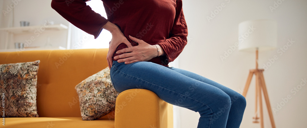 Woman with strong hip pain at home. - obrazy, fototapety, plakaty 