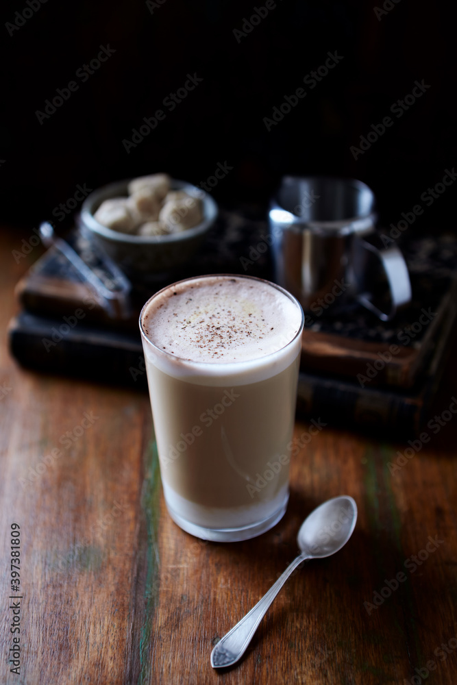 Coffee with milk on dark wooden background. Close up. Coffee with milk on dark wooden background. Close up.
