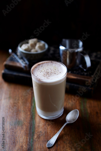 Coffee with milk on dark wooden background. Close up. 