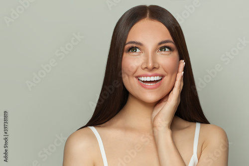 Leinwand Poster Happy surprised woman spa model with clear skin and long healthy straight hair
