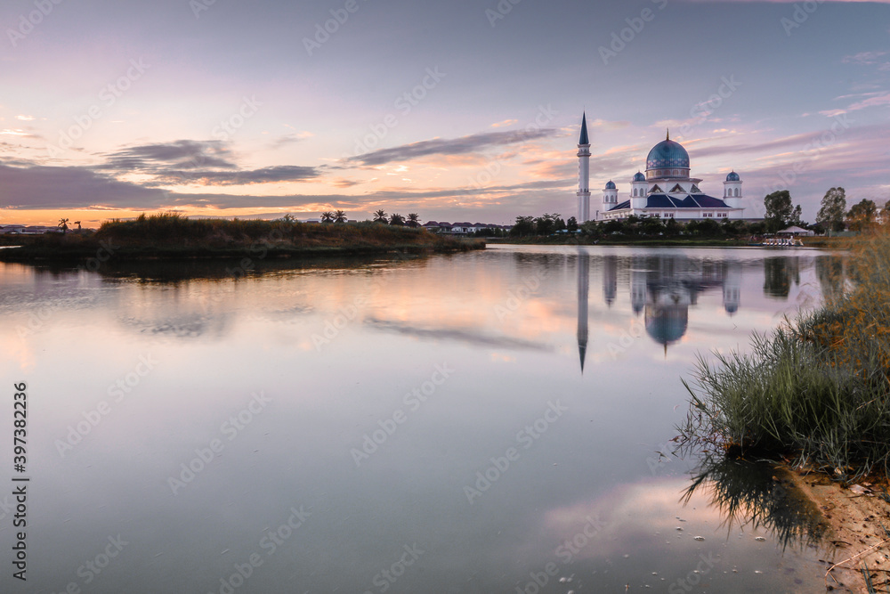 sunrise over the lake with reflection of the mosque