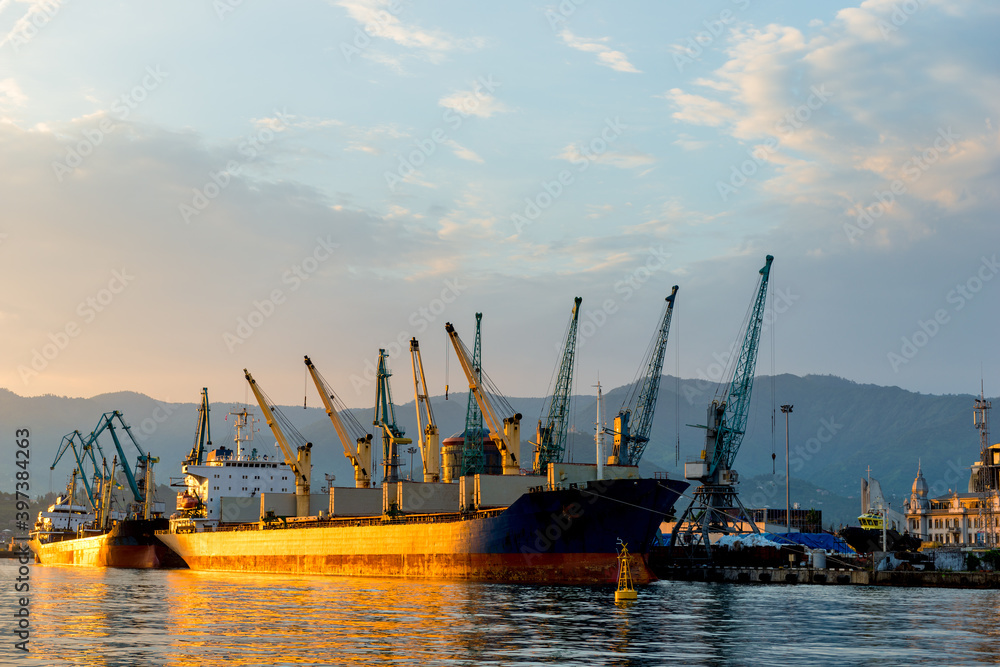 view of loading cranes in the seaport at sunset, Batumi, Georgia
