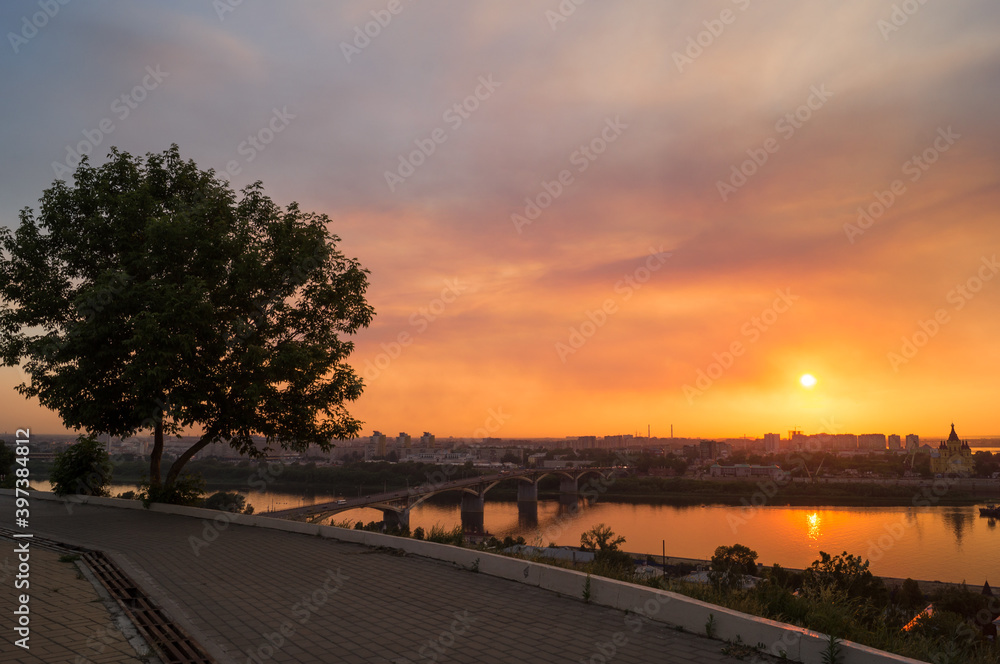The warm bright summer sunset in the city. Oka river, Nizhny Novgorod, Russia.