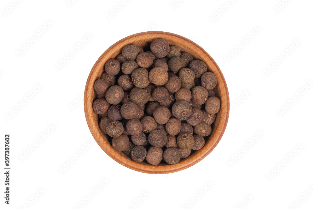 Allspice pepper, peppercorns in wooden bowl isolated Allspice pepper, peppercorns in wooden bowl isolated