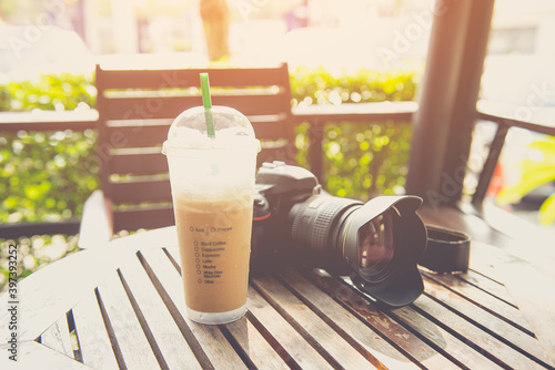 coffee cup with camera digital in coffee shop vintage color