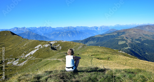 Woman overlooking mountains and the Alps from Monte Guglielmo. Lago d'Iseo, Brescia, Lombardy, Italy. photo
