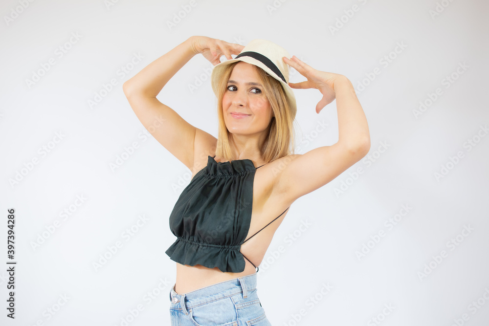 Young beautiful woman wearing straw hat over isolated white background looking away to side with smile on face, natural expression. Laughing confident. Young beautiful woman wearing straw hat over isolated white background looking away to side with smile on face, natural expression. Laughing confident.