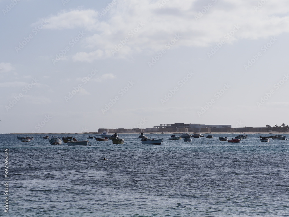 Many fishing boats on Atlantic Ocean in african Santa Maria town at Sal island in Cape Verde, clear blue sky in 2019 warm sunny spring day on March.