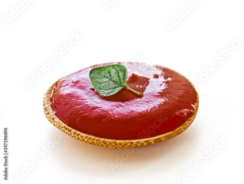 Ketchup or tomato sauce with oregano leaf on white background