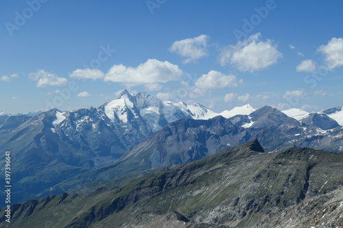 Panoramic view from top of Hohe Sonnblick in Austrian Alps on Gro?glockner. The whole area is very steep and dangerous, with many lose stones. Many mountain chains in the back. Sunny day. Expedition © Chris