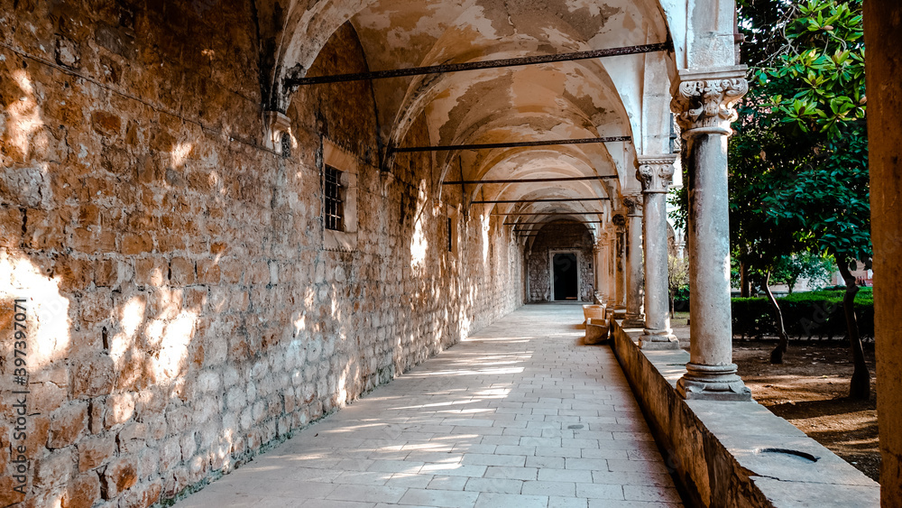 Fototapeta premium Hallway of Benedictine Monastery on Lokrum island. Columns and hallway of the monastery with no people on Lokrum island near Dubrovnik