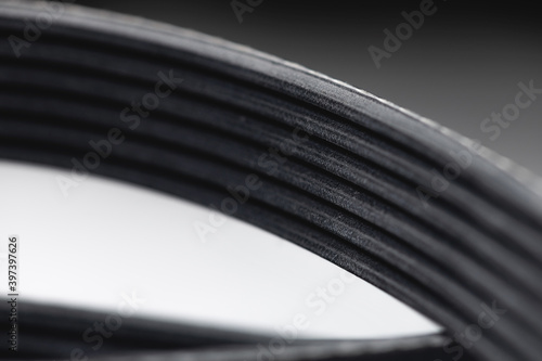 New belt for automobile poly-V-belt electricity generator. Macro close-up blank for background