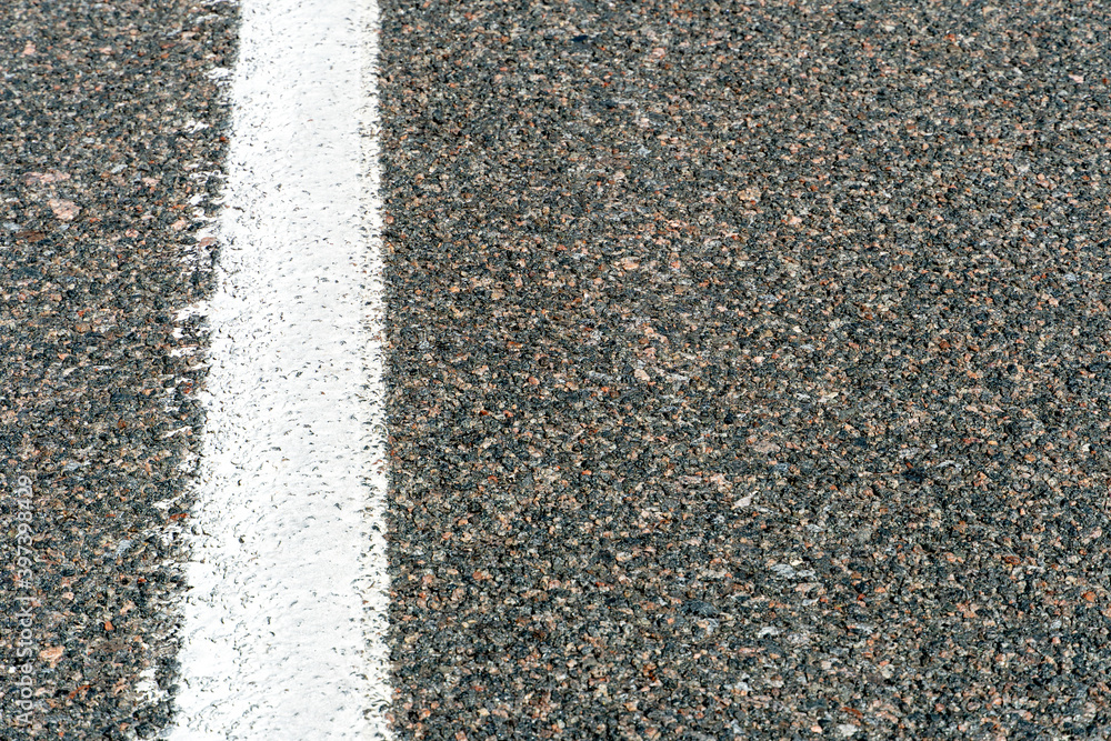 Empty asphalt road. New fresh asphalt pavement away from the city. Development of rural infrastructure. Road marking lines close up. Empty asphalt road. New fresh asphalt pavement away from the city. Development of rural infrastructure. Road marking lines close up.