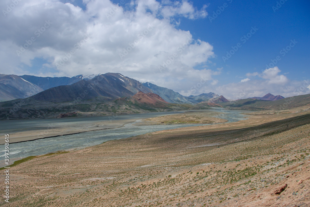 Stunning pastel colors of high-altitude mountain landscape along the Pamir Highway close to Kyzyl Art border in the high mountains of Gorno-Badakshan, Murghab district, Tajikistan
