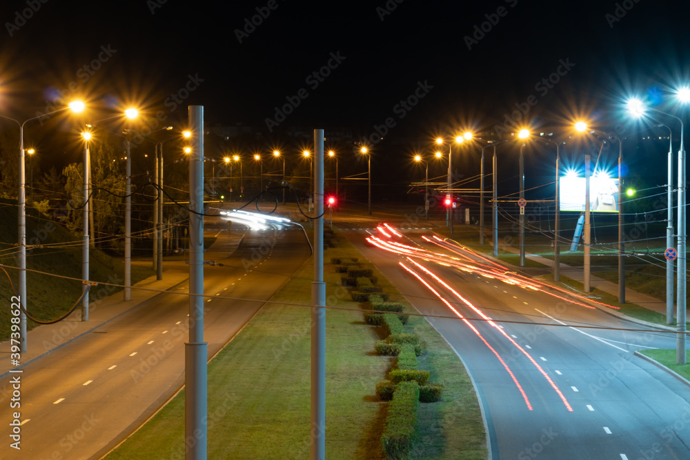 Night city light lines from cars. cars in highway with blur motion. Street view of the modern city at night. A lot of light from car headlights, advertising banners and night lights. Night city light lines from cars. cars in highway with blur motion. Street view of the modern city at night. A lot of light from car headlights, advertising banners and night lights.