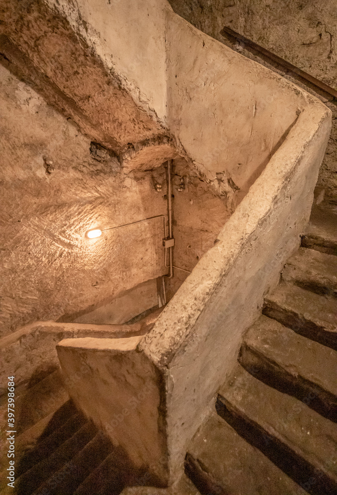 Obraz premium Naples, Italy - built more than 2500 years ago, and widely used during World War II, the Naples subterranean system is a main turist attraction today. Here in particular the staircase