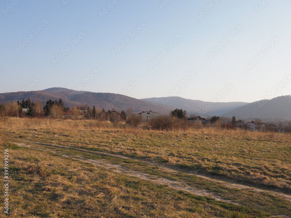 Fototapeta premium Scenic Silesian Beskid Mountains range in european Bielsko-Biala city at Silesian district in Poland, clear blue sky in 2020 warm sunny spring day on April.