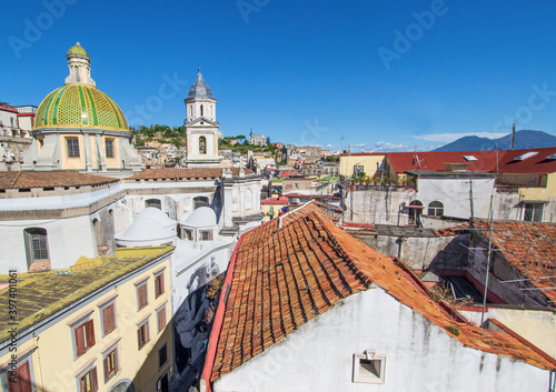 Naples, Italy - located over the Catacombs of San Gaudioso, the Church of Santa Maria della Sanità  is very recognizable for its green dome and Mount Vesuvius on the background photo