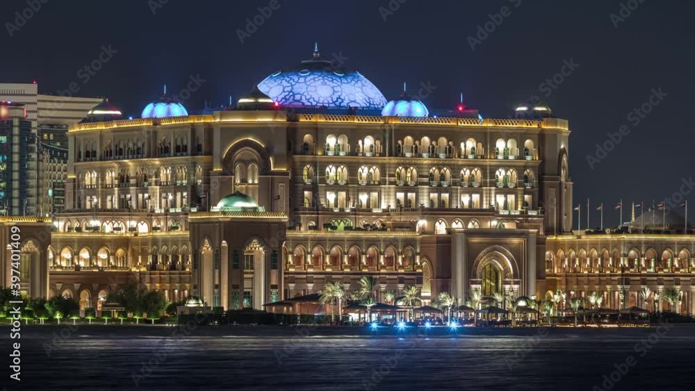Emirates Palace illuminated at night timelapse, Abu Dhabi, United Arab Emirates. Lights reflected in water Emirates Palace illuminated at night timelapse, Abu Dhabi, United Arab Emirates. Lights reflected in water