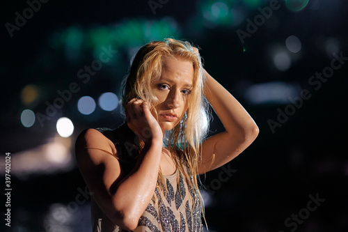 Portrait of beautiful young woman at night time.