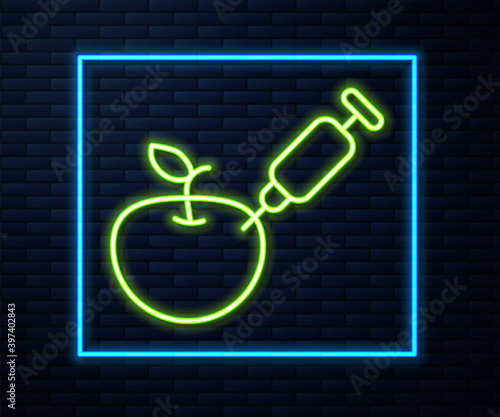 Glowing neon line Genetically modified apple icon isolated on brick wall background. GMO fruit. Syringe being injected to apple. Vector.
