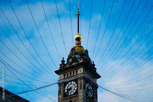 Clock tower with light strings and a golden top