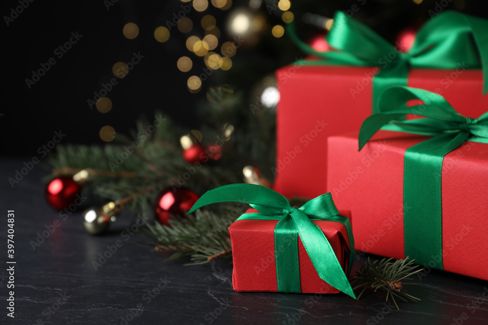 Gift boxes and Christmas decorations on dark grey table, space for text Gift boxes and Christmas decorations on dark grey table, space for text
