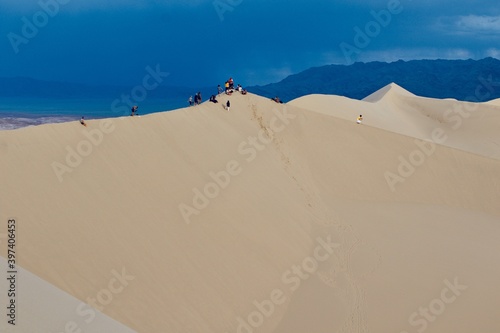 Tourists on the top of Gobi desert sand dunes