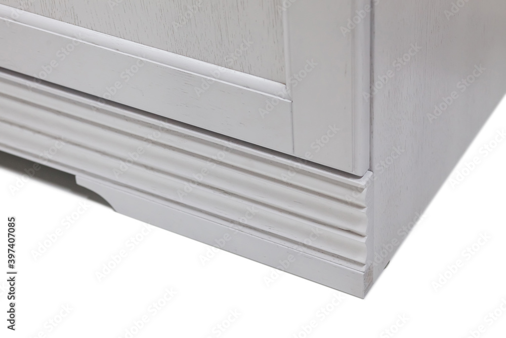 Bottom corner of a white modern kitchen cabinet. Bottom corner of a white modern kitchen cabinet.