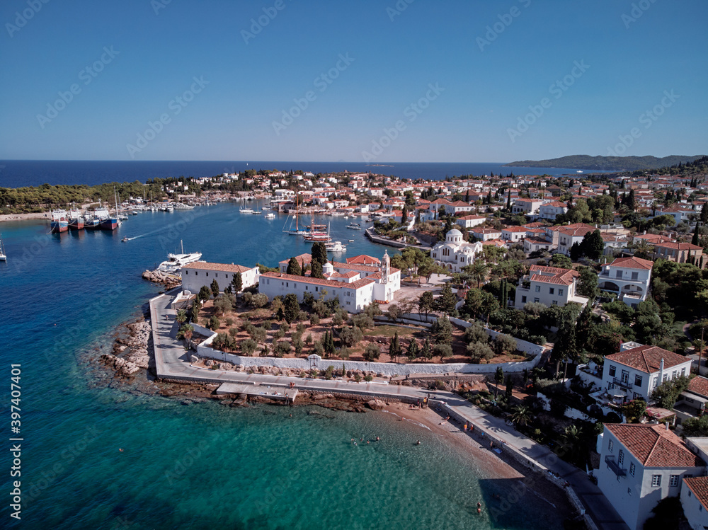 Aerial shot of Spetses Island coast in Greece. A famous tourist destination on the Aegean sea. Old town and harbour view.