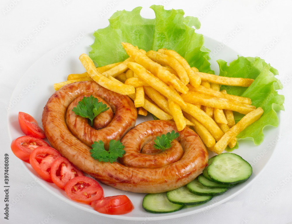 Chicken sausage with French fries, tomatoes, cucumbers and lettuce Chicken sausage with French fries, tomatoes, cucumbers and lettuce