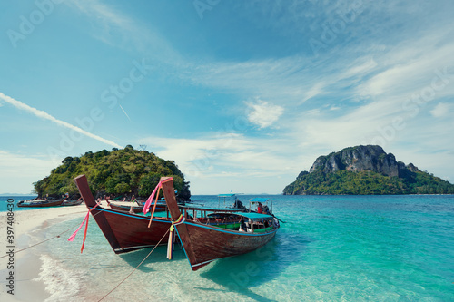 Beautiful landscape with traditional longtail boats, rocks, cliffs, tropical white sand beach. Traveling by Thailand. © luengo_ua