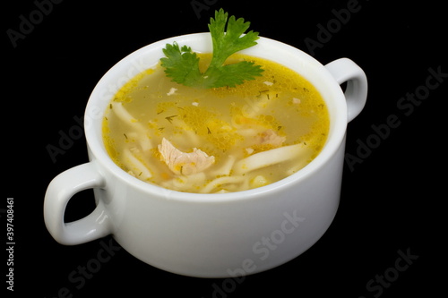 Chicken noodle soup in a white tureen