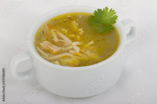 Chicken noodle soup in a white tureen