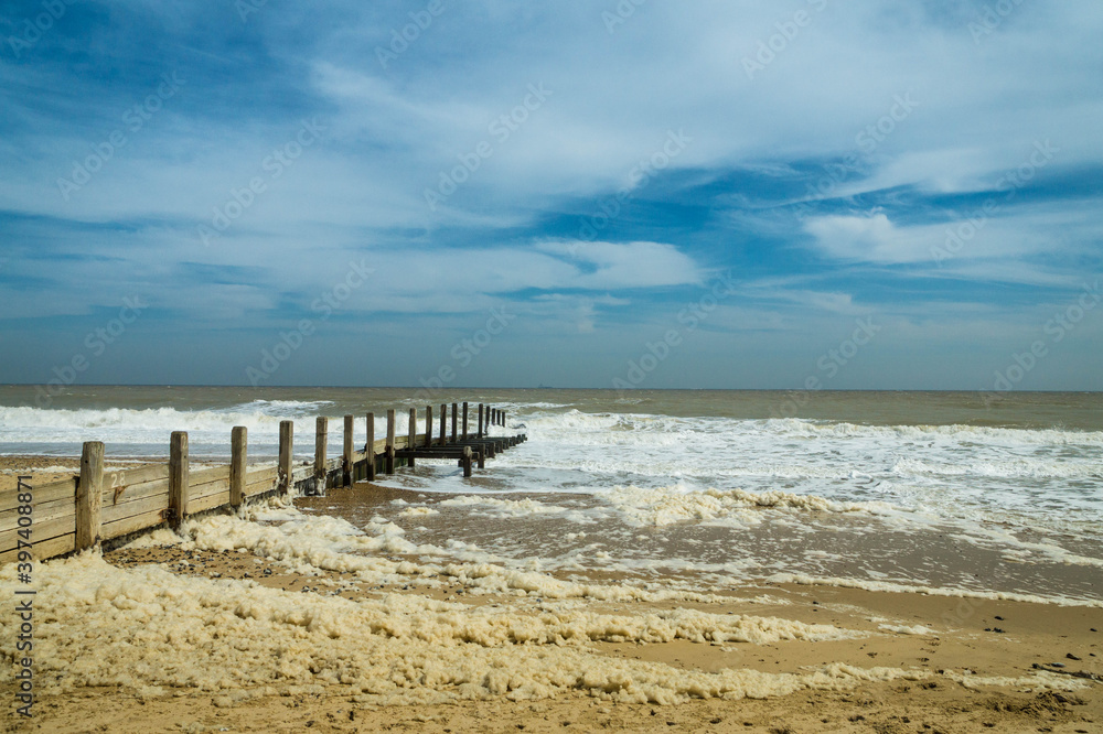 View on the North Sea at Horsey Gap. Waves and groins in Norfolk. East coast of UK. photographed n a sunny day in April 2017 View on the North Sea at Horsey Gap. Waves and groins in Norfolk. East coast of UK. photographed n a sunny day in April 2017