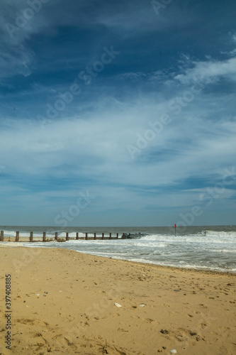 View on the North Sea at Horsey Gap. Waves and groins in Norfolk. East coast of UK. photographed n a sunny day in April  2017